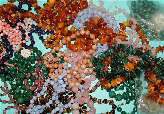 A collection of hardstone, coral and amber bead necklaces.